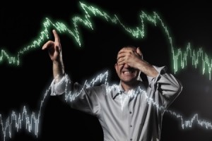 10874458 - scared trader pointing to stock market charts with eyes closed.